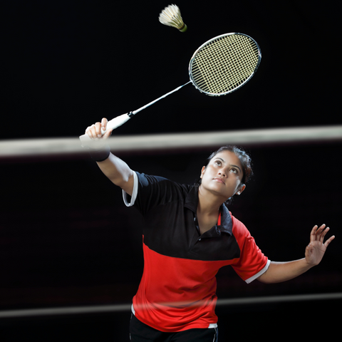 BADMINTON PLAYER ATTACKING THE FRONT COURT