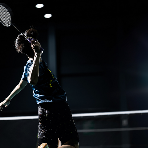 BADMINTON PLAYER DOING A SMASH