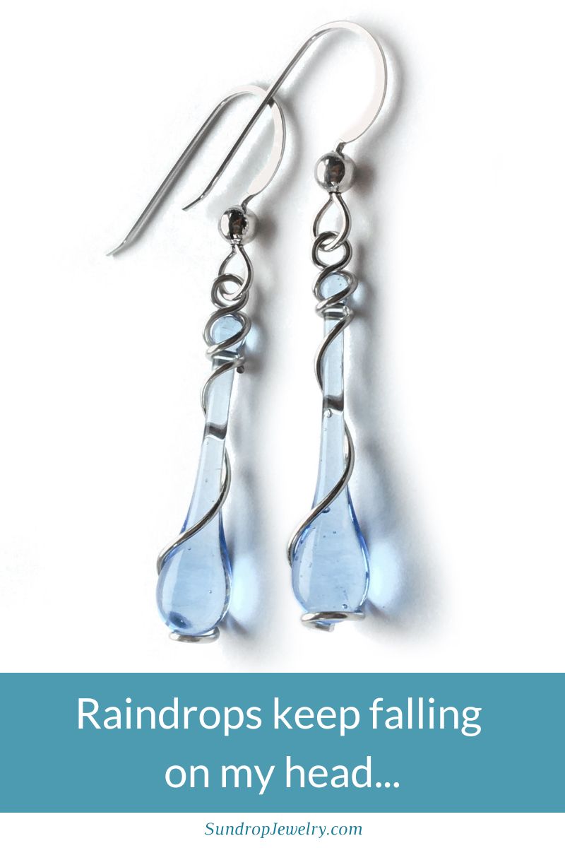 Pale pastel blue glass earrings wrapped in a spiral of silver, handmade by Sundrop Jewelry, part of the new Stormy Weather collection