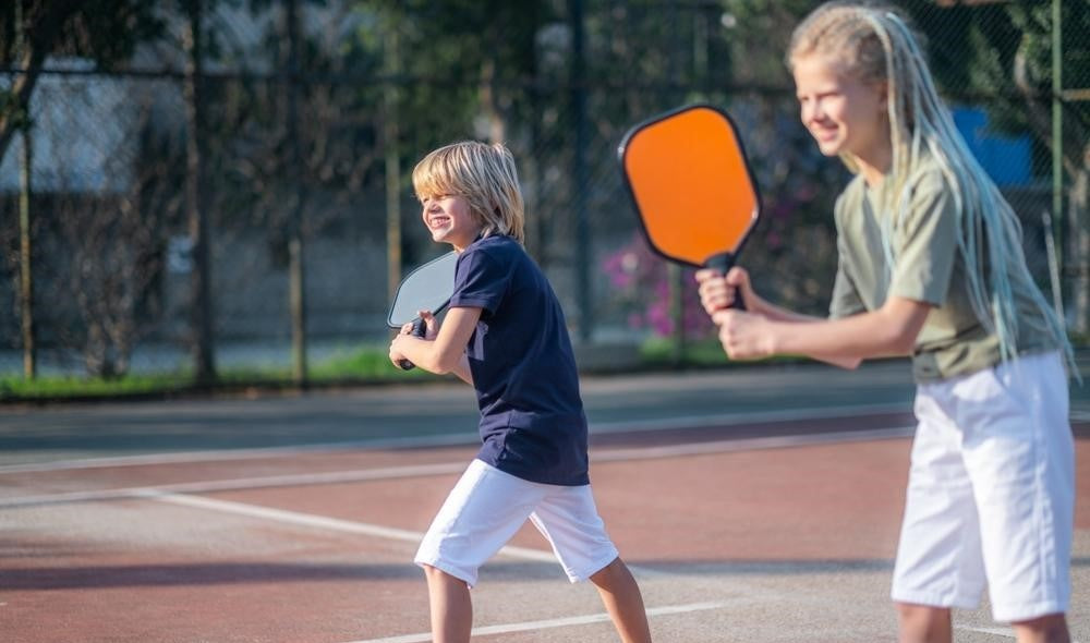 children playing pickleball