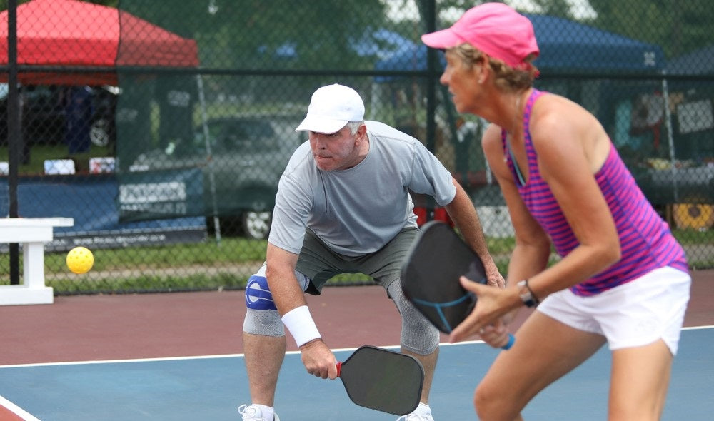 old couple during pickleball game