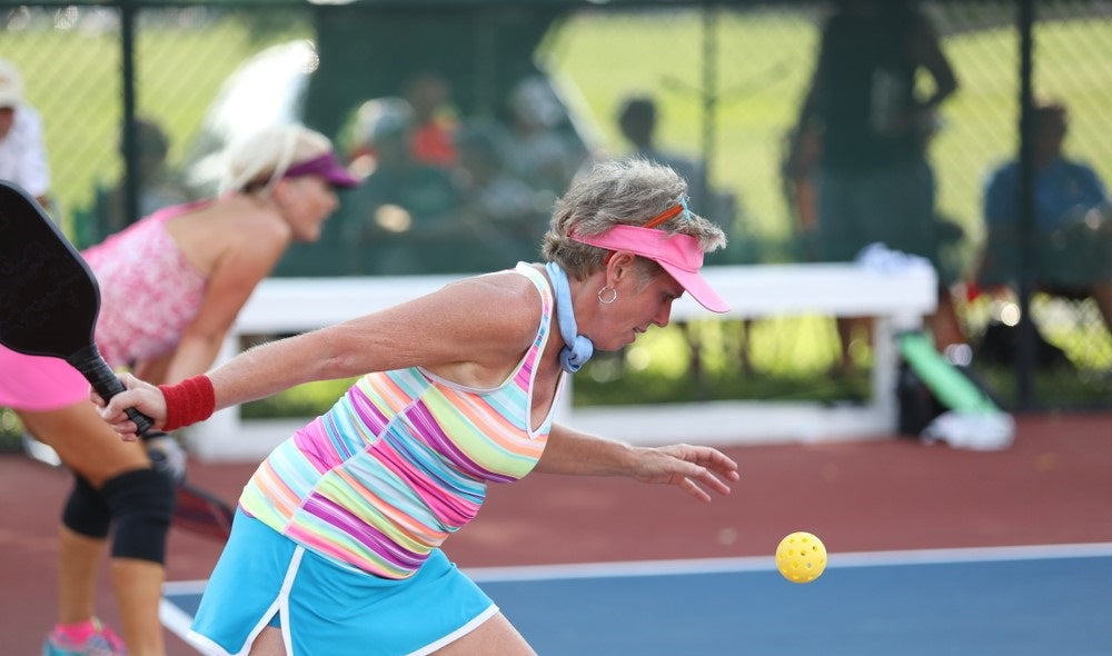 old women playing pickleball