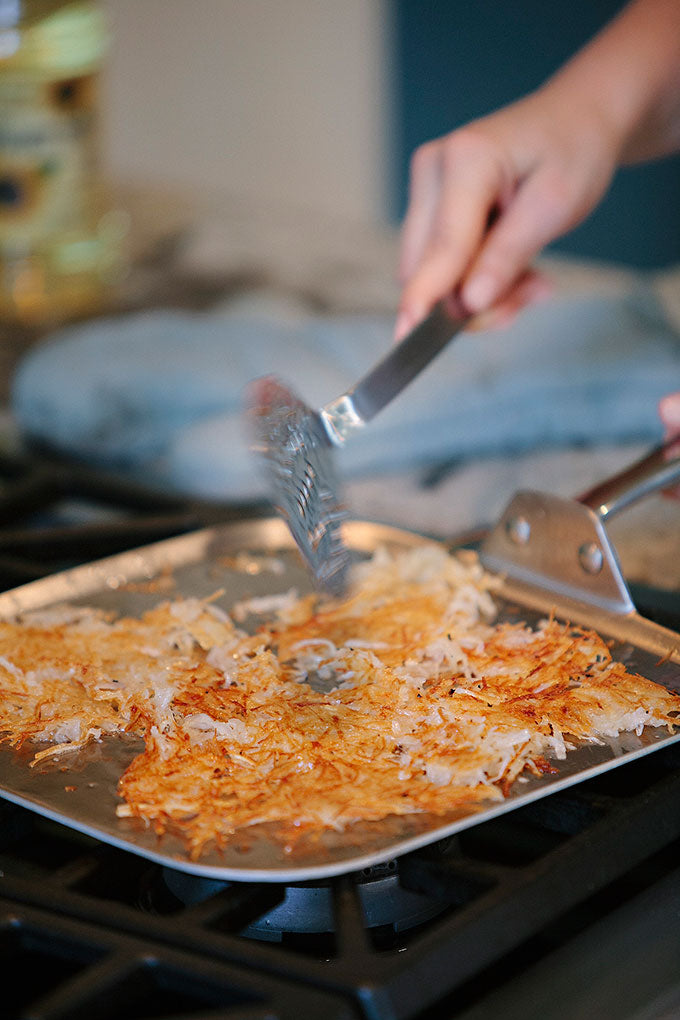 Crispy Hash Brown being cooked in square griddle