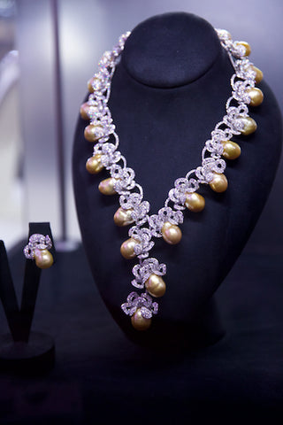 Couture white diamond and golden pearl necklace and earrings