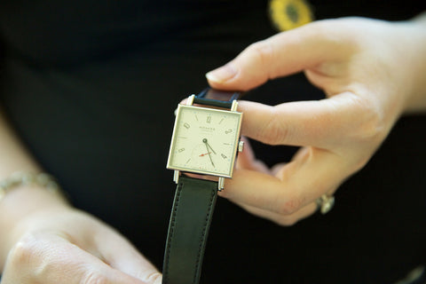 Photo of Nomos square watch being held in two hands