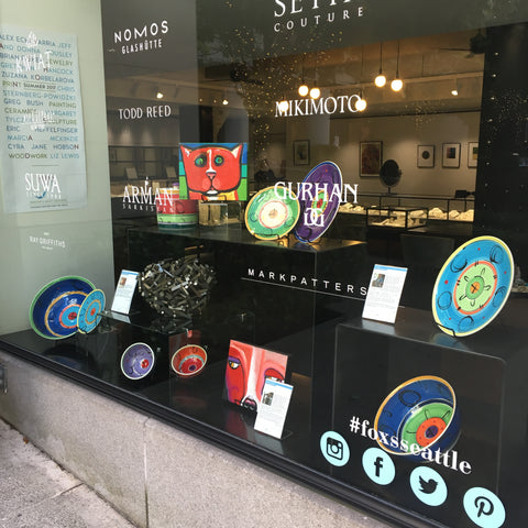 Photo of Fox's Seattle showcase window with pottery and paintings from Vashon Island.