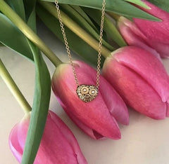 Alex Sepkus 18k heart necklace on tulips