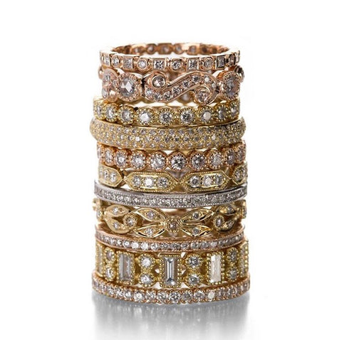 large stack of Sethi Couture 18k yellow, rose, and white gold wedding bands