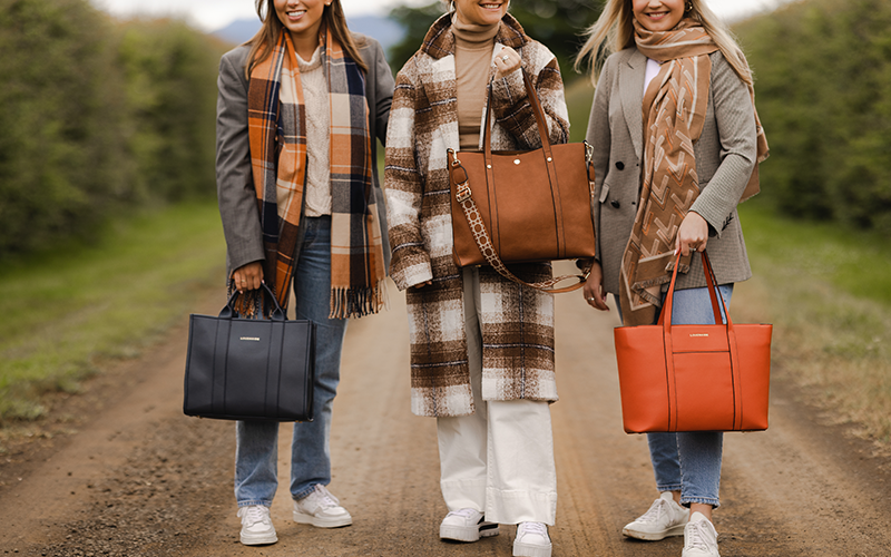 The women wearing winter coats and tote bags