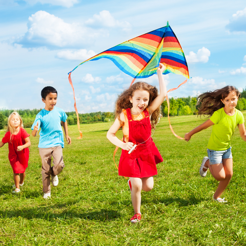 kids playing in the park camp outdoors grass green fun making  a kite 