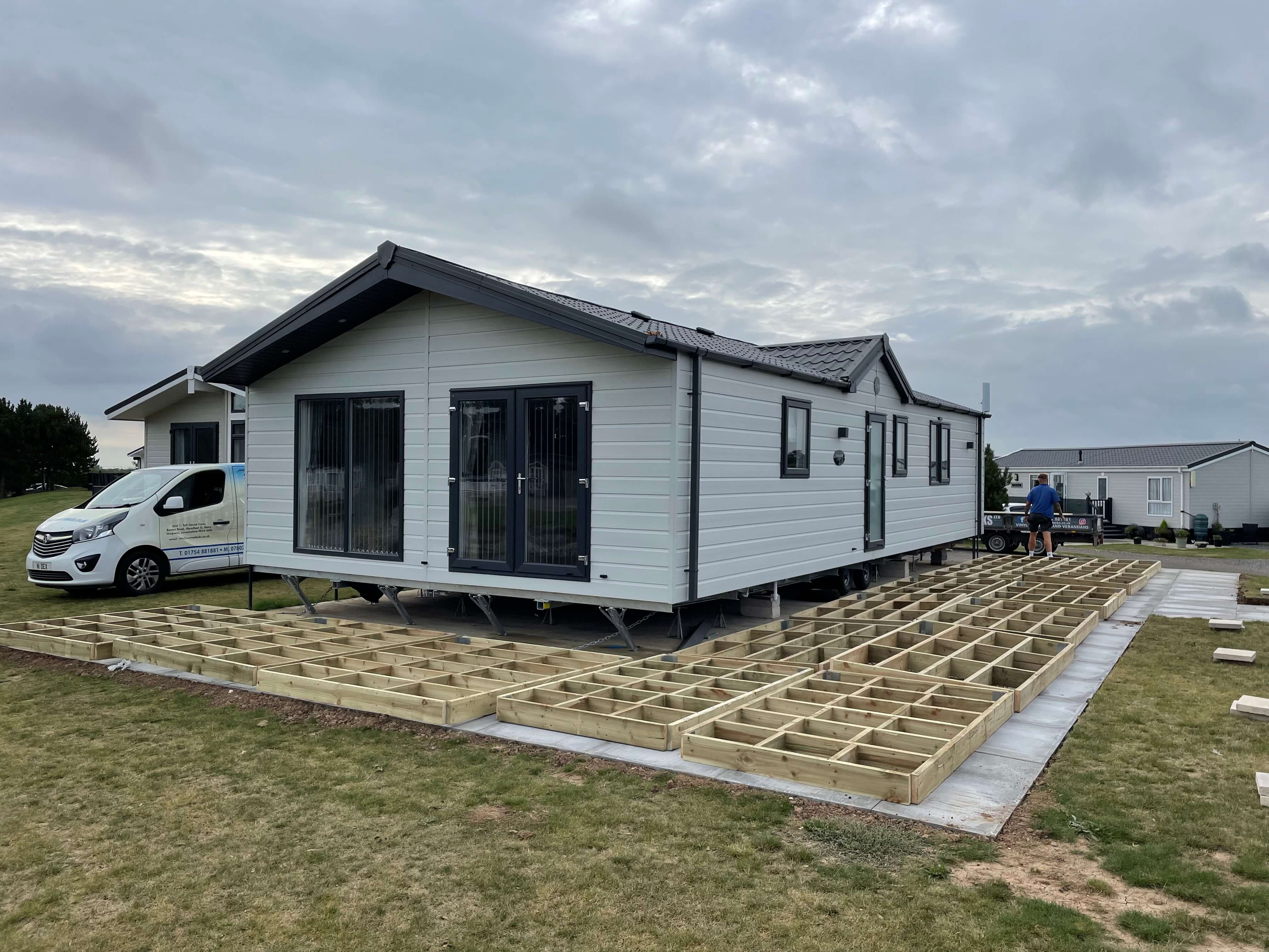 Footings of decking being built by a caravan