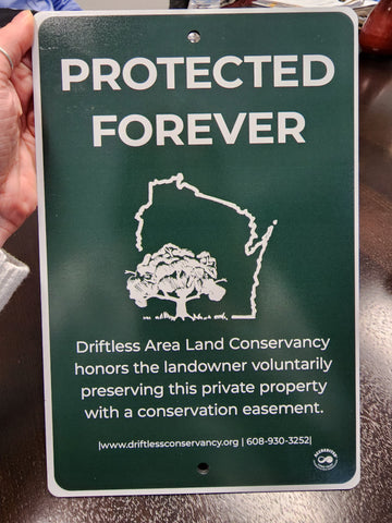 conservation easement sign 'protected for all time' at three waters reserve 