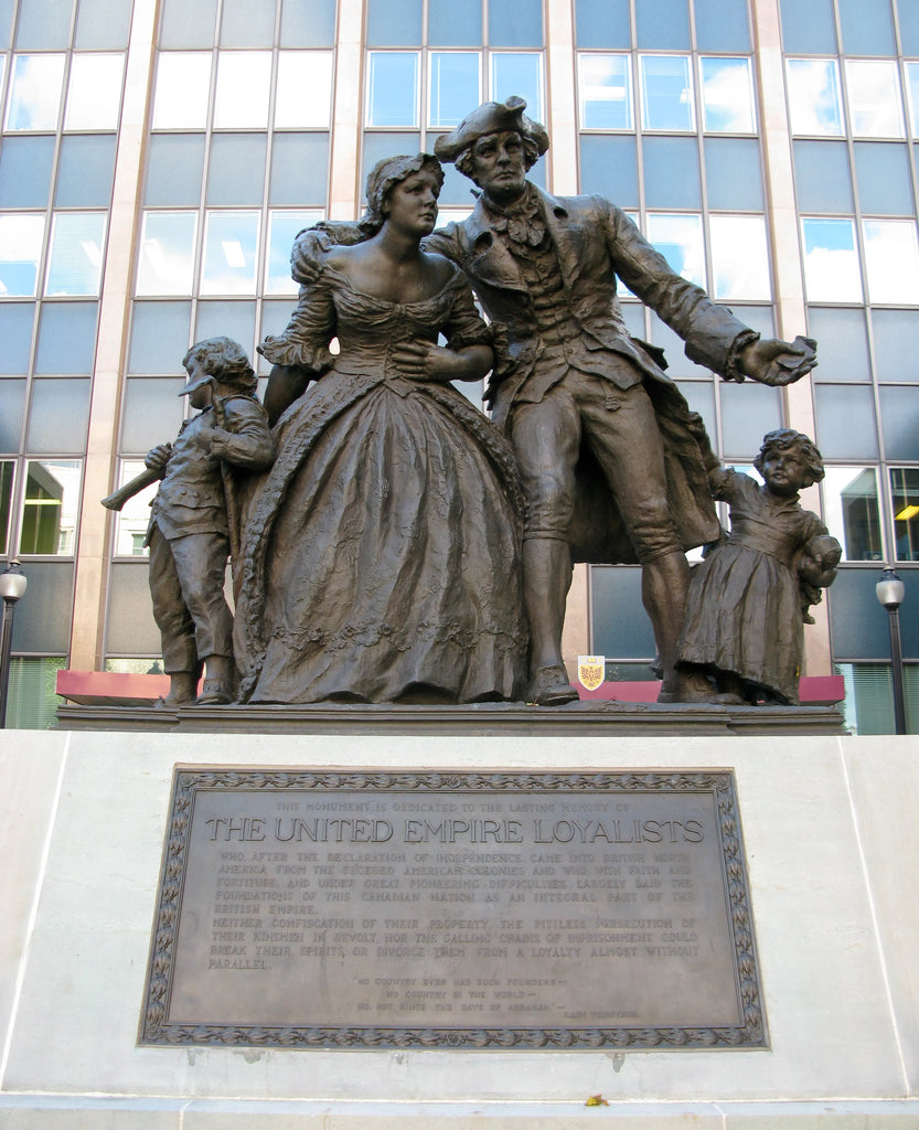 Photo of the statue from farther away, showing the pedestal with a plaque on it