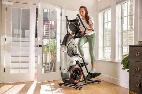 Lady running on elliptical machine