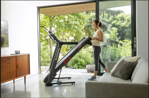 Lady running on a treadmill in a cozy place