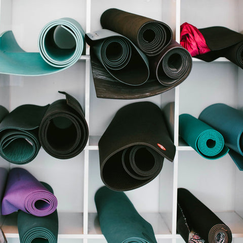 A shelf with yoga mats