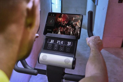 Man checking out the screen of exercise bike