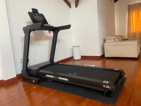 Treadmill placed in a wooden flooring in a room