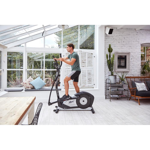 man working out on elliptical machine