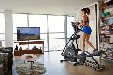 girl running on elliptical machine