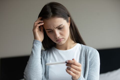 woman holding pregnancy test