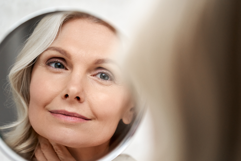 older woman looking in a mirror