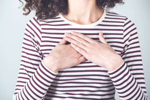 woman with hand over heart