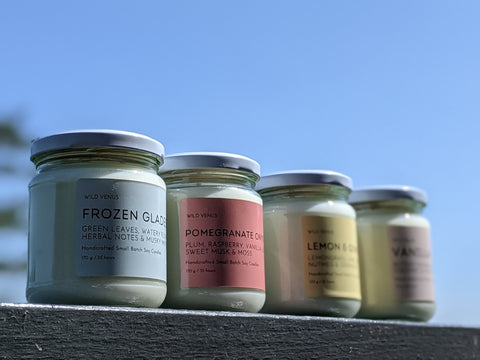 A row of 4 soy wax candles against the blue sky.