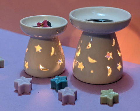 A Large and Small White Wax Warmer with Stars and Moons