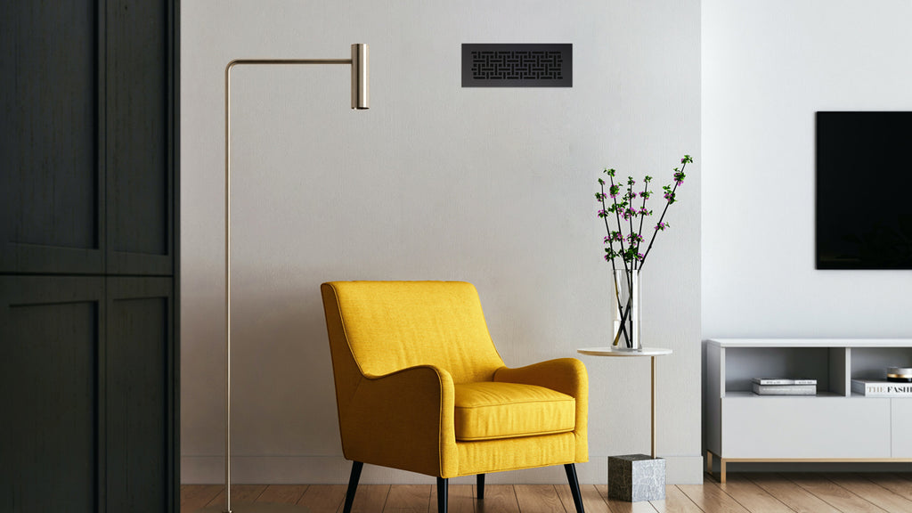 Living room with black accents like a vent cover and feature wall.