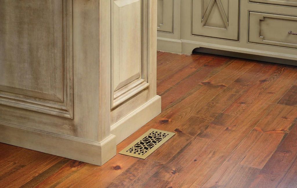 Floor vent with ornate cover in a kitchen.