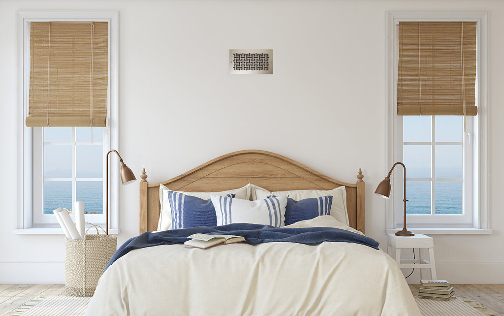 Bedroom with the bed between two window and register centered on the wall near the ceiling.