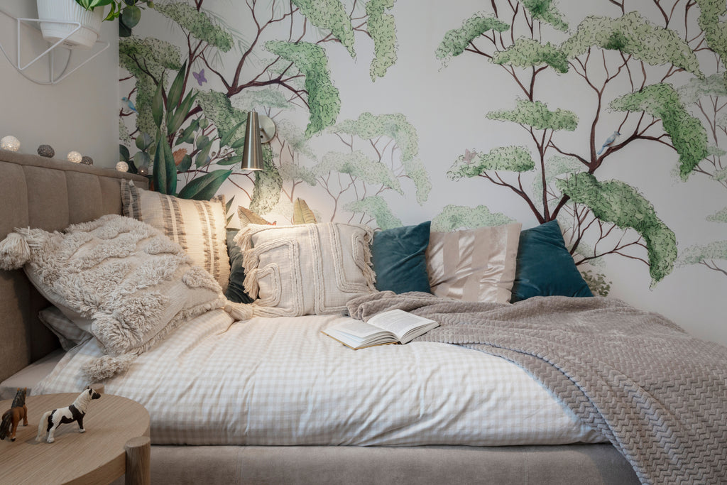 Comfy bedroom with peel and stick wall paper on the wall.