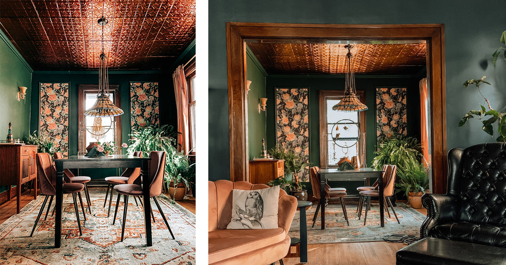 Dining room with green walls and Victorian tin ceiling tiles.