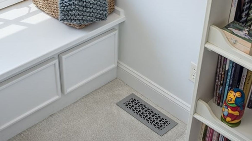 Children's bedroom with silver floor register in a corner of the room.