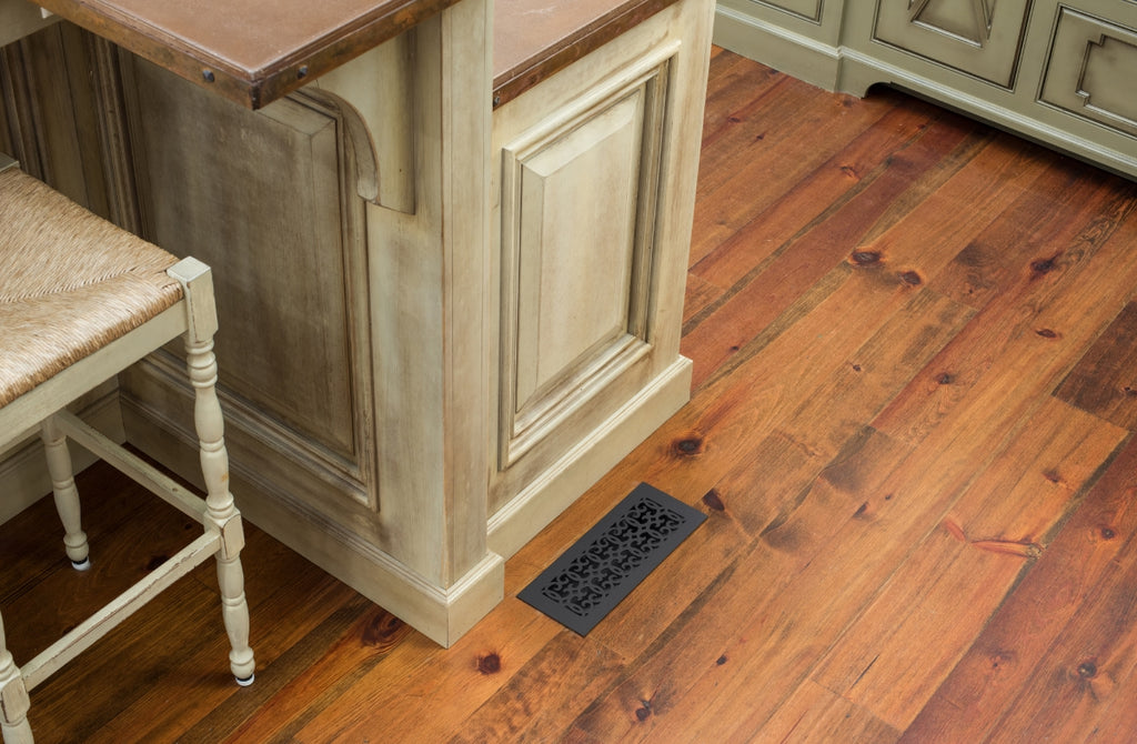 Rustic kitchen with floor register in black cast iron.