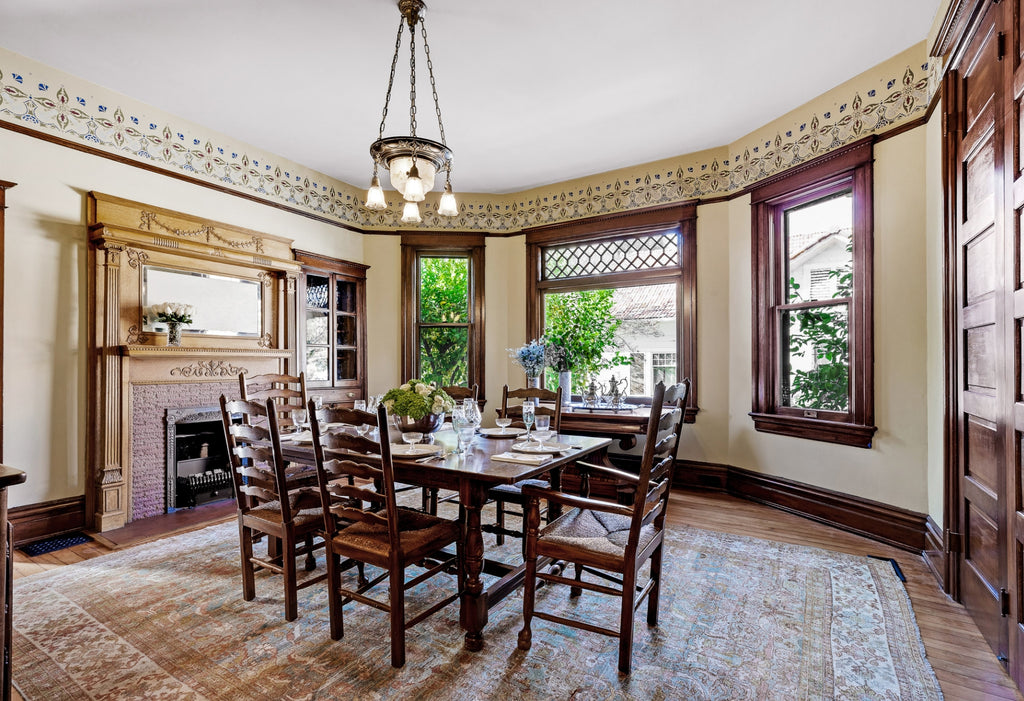 Large dining room in a Victorian style with dark wood trim.
