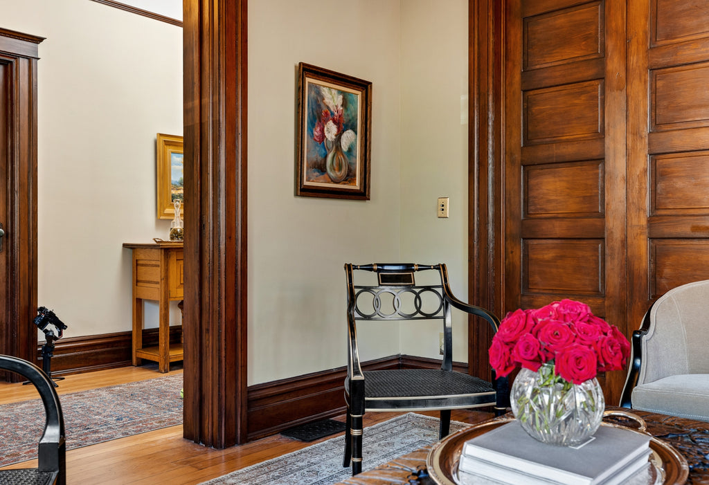 A corner of a beautiful Victorian house with dark wood trim.
