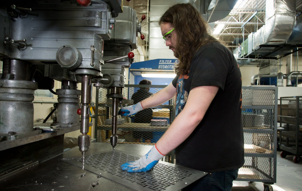 Person countersyncing mounting holes.