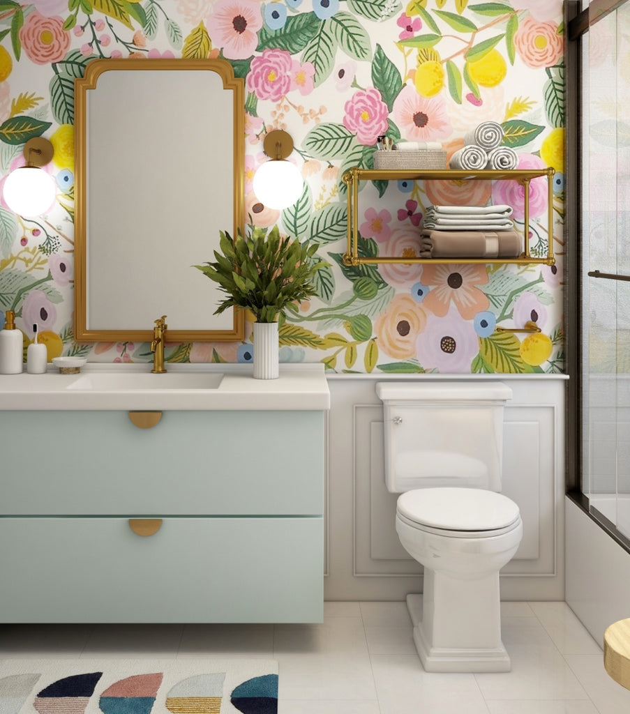 Gold-colored bathroom shelving on a floral-themed wall