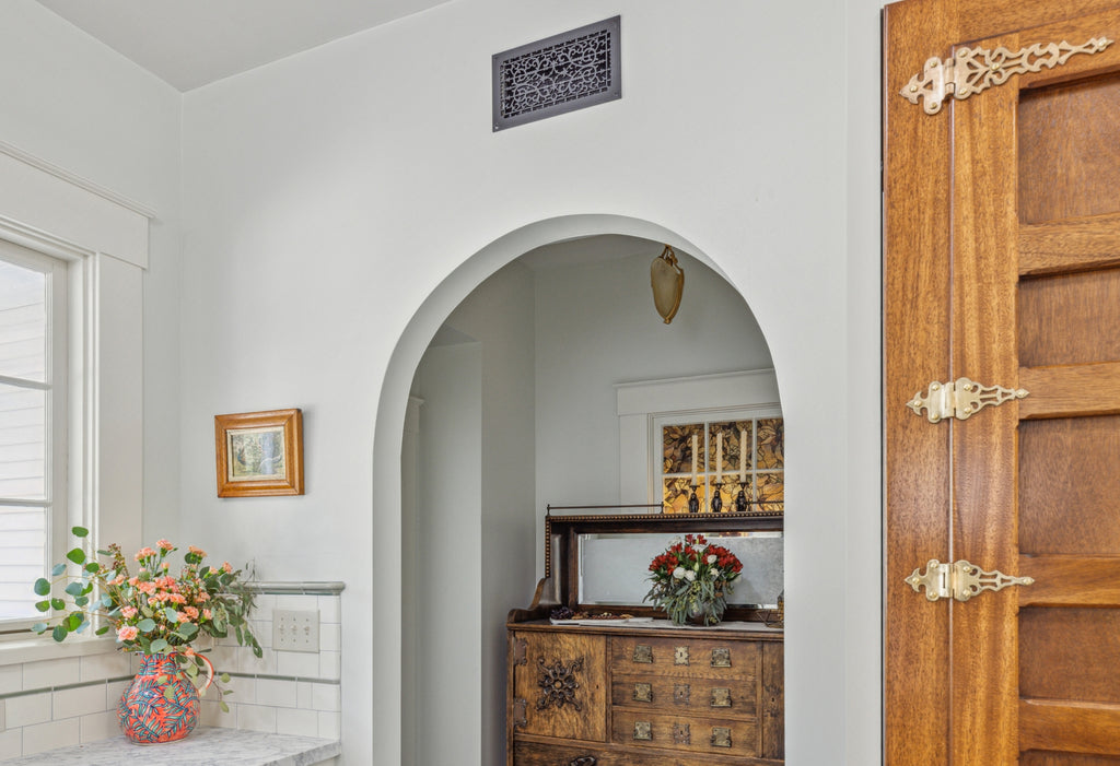 Close up of arched door in Dutch Colonial kitchen.