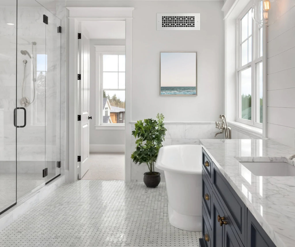 Large marble bathroom with silver wall register.