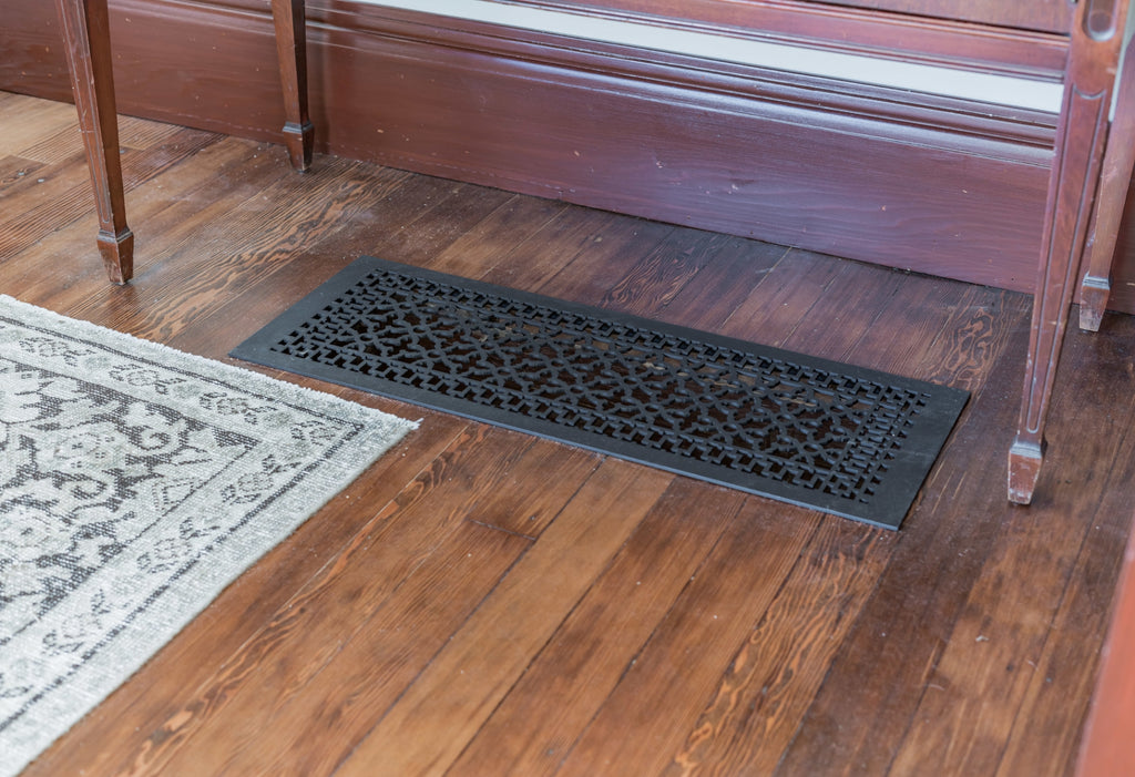 Close up of Reggio Register under a console table on the floor.