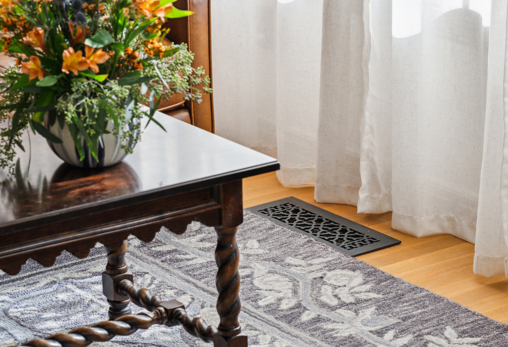 Close up of an Edwardian style room with historic style register on the floor.