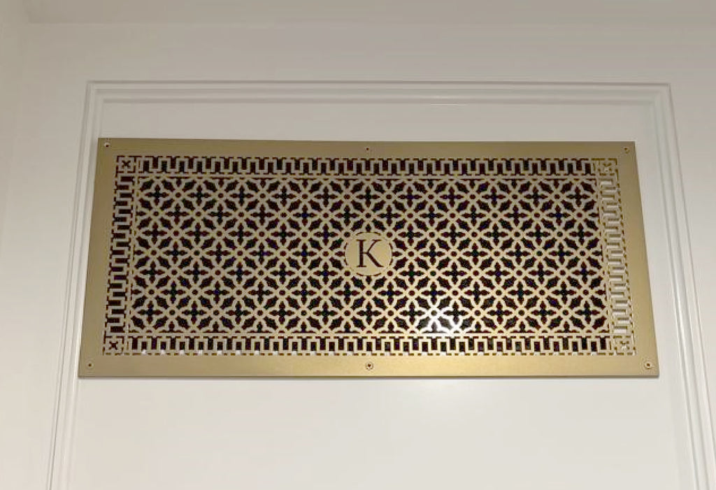 Custom vent cover in gold with initial R.