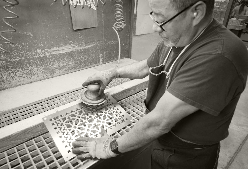 Craftsperson finishing a vent cover.