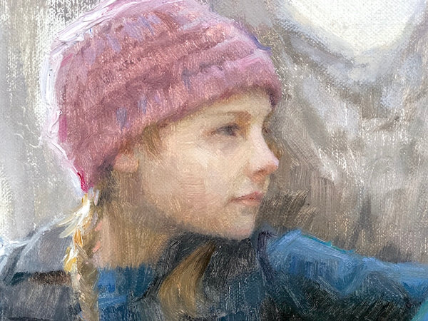 Young girl with pink winter hat in tree, tree climbing