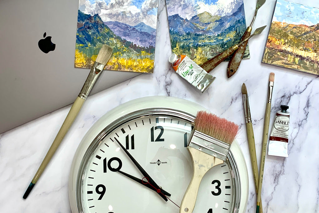 clock, laptop, paintings, art supplies on marble background creative entrepreneur, art business, time management