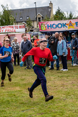 a photo of late Herbie McLean running in Killin Highland Games Hill Race that the Real food cafe sponsors to pay him a tribute