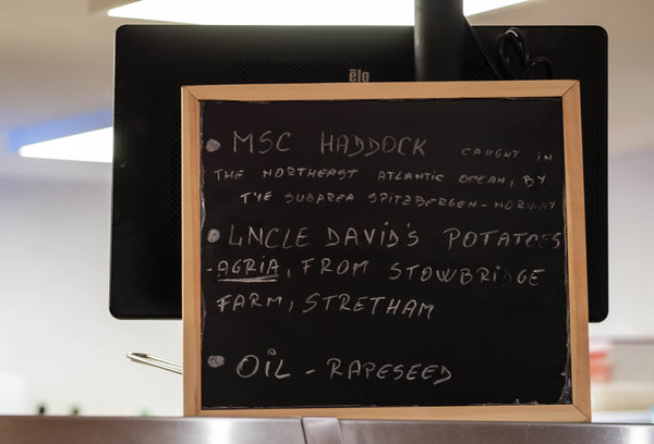 Blackboard at the Real Food Cafe Tyndrum showing what fish is used for fish & chips and what oil is used for frying